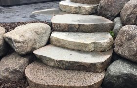 Top view of a landscape stairs made from cut fieldstone boulders