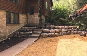 Tiered retaining wall made from fieldstone boulders