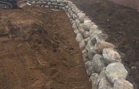 Newly constructed boulder retaining wall