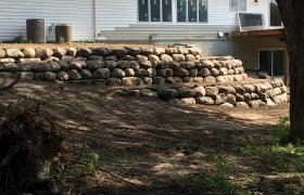 Side view of a multi-level boulder retaining wall